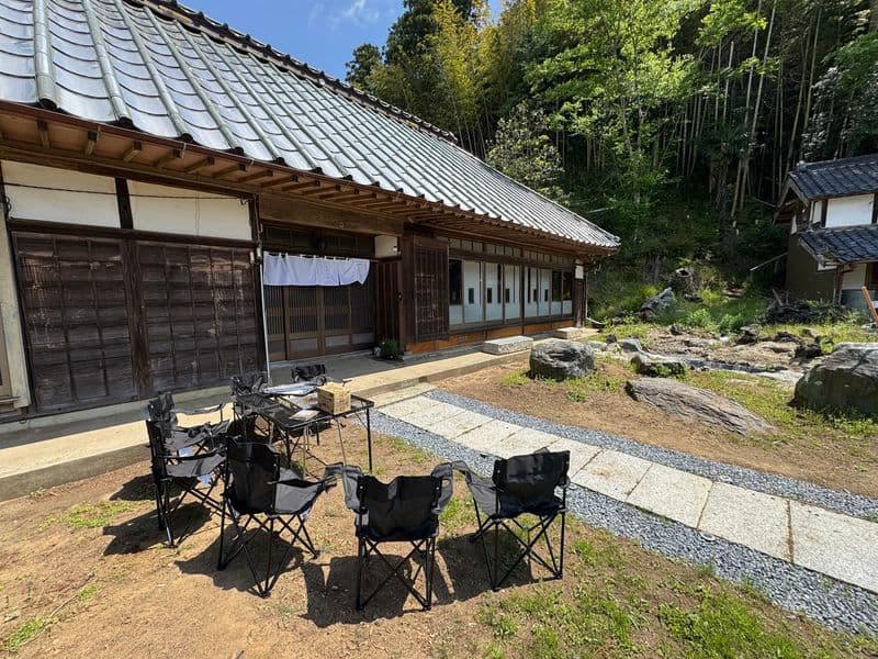 Outdoor chairs and a barbecue table set up in the garden