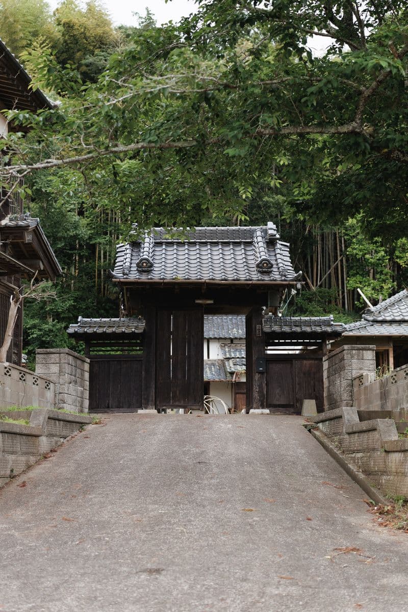 The tiled wooden gate and the sloped concrete approach