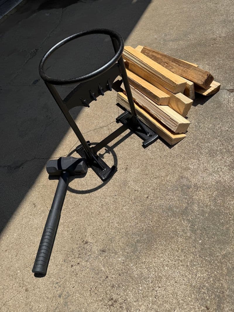 A kindling splitter, hammer and freshly split firewood