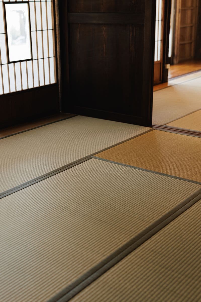 Close-up of tatami matting and the base of an open sliding door
